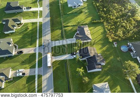Aerial View Of American Yellow School Bus Driving On Suburban Street For Picking Up Children For The