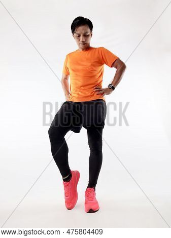 Asian Male Runner Warming Up Prepararing His Body Before Running Workout. Warming Up His Ankle, Stud