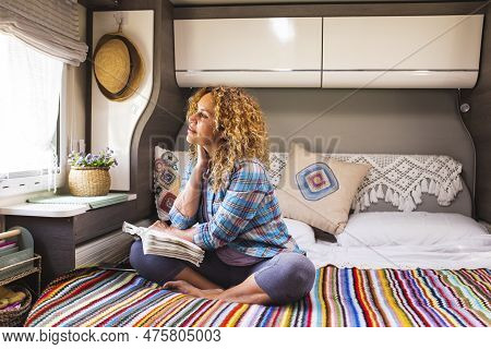 Daydreamer Female People Enjoying Freedom And Relax Inside A Camper Van Bedroom Sitting On Bed And L
