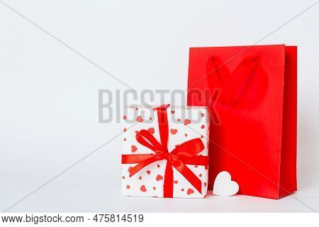 Shopping Bag With Gift Box On Colored Background Perspecrive View. Space For Text Holiday Concept.