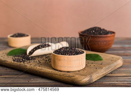 Quinoa Seeds In Bowl And Spoon On Colored Background. Healthy Kinwa In Small Bowl. Healthy Superfood