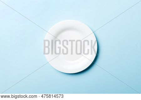 Top View Of Isolated Of Colored Background Empty Round White Plate For Food. Empty Dish With Space F