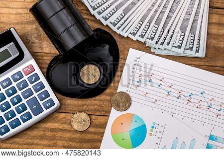 Spilled Crude Oil, Money, Graph And Calculator On The Workplace.