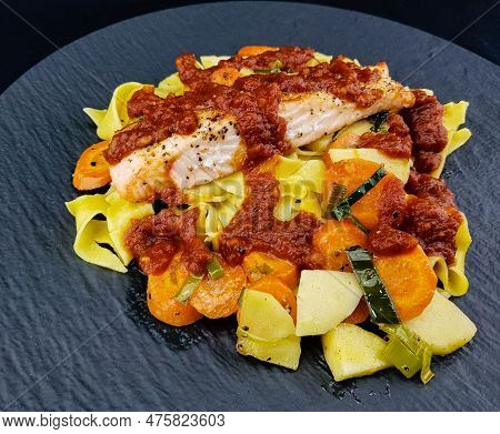 Italian Pappadelle Pasta With A Roasted Salmon Steak And Vegetables