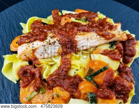 Italian Pappadelle Pasta With A Roasted Salmon Steak And Vegetables