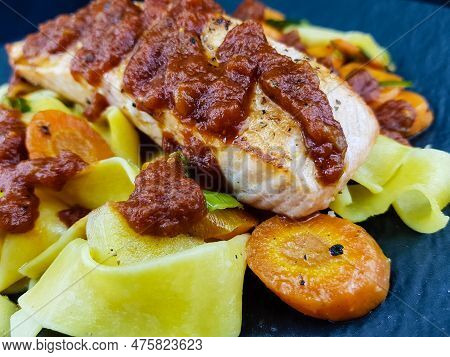 Italian Pappadelle Pasta With A Roasted Salmon Steak And Vegetables