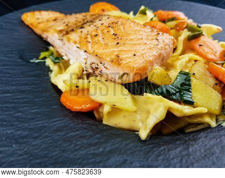 Italian Pappadelle Pasta With A Roasted Salmon Steak And Vegetables