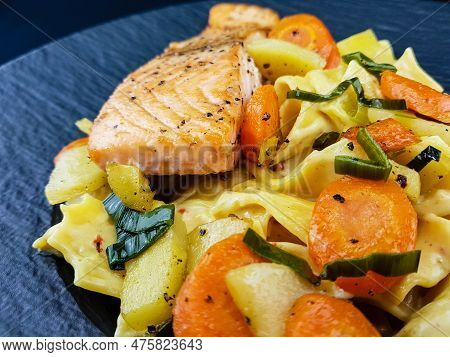 Italian Pappadelle Pasta With A Roasted Salmon Steak And Vegetables