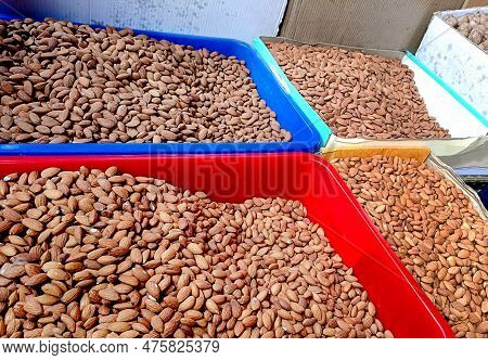 Peeled Almonds Are Stired In A Basket In A Street Shop Of India.