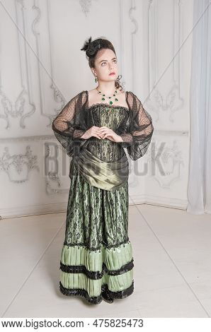 Beautiful Young Woman Wearing Green Medieval Vintage Victorian Style Dress