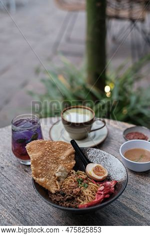 Portrait Or Vertical Shot Of A Bowl Of Fried Chinese Noodles With Shredded Chicken, Char Siu, A Half