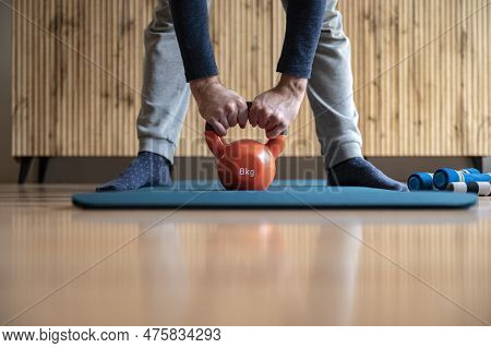Closeup View Of Male Hands About To Lift An 8 Kilogram Kettlebell Weight In A Conceptua Image Of Wor