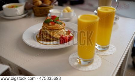 Pancakes Covered With Jam. The Chef Pours Jam On Pancakes For Breakfast In A Hotel Room. Fritters Fo
