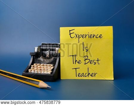 Black Vintage Typewritter And Pencil With The Word Experience Is The Best Teacher On Blue Background