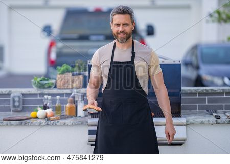 Man Cooking Tasty Food On Barbecue Grill Outdoors. Man Cooking Barbecue Grill At Backyard. Chef Prep