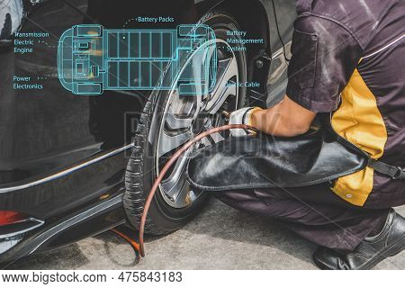 Cropped Shot Of Mechanic Pumping Up Car Tire.