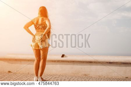 Woman Summer Dance. Silhouette Of A Happy Woman Who Dances, Spins And Raises Her Hands To The Sky. A