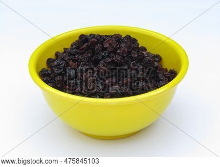 Dried Blackcurrant In A Bowl On White Background