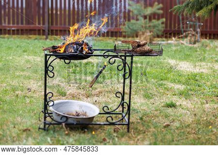 A Barbecue Garden Trolley And Strong Fire With A Falling Firebrand, Concept Of A Reckless