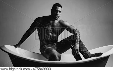 That Means Its Bath Time. Strong Latino Man With Tattoo On Muscular Torso Sitting In Bath. Atheltic 