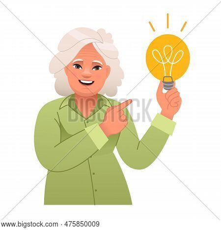 Elderly Woman Holds A Light Bulb In Her Hand. Old Lady Has An Idea. Portrait Of A Happy Pensioner. S