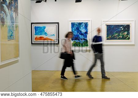 Parma, Italy - October 2022: People Walking And Admiring Paintings In A Modern Art Gallery.