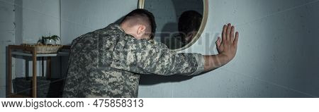 Soldier In Uniform With Mental Problem Standing Near Mirror At Home At Night, Banner.