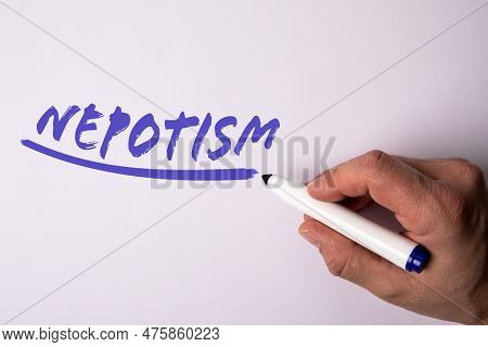 Nepotism. Handwriting Text With Marker On A White Background