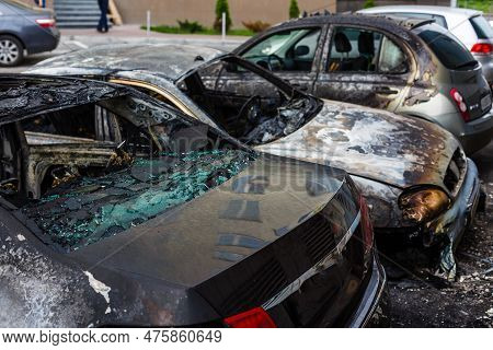 Burned Car. Set Fire To Cars In Parking Lot. Bandit Wars, The Destruction Of The Fire Machine After 