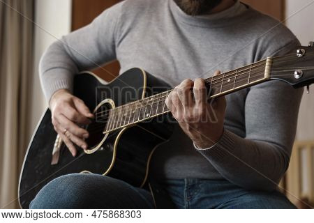 Playing The Guitar. Strumming Acoustic Guitar. Musician Plays Music. Man Fingers Holding Mediator. M