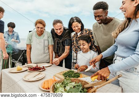 Multi Generational People Having Fun Doing Barbecue At House Rooftop - Happy Multiracial Friends Coo