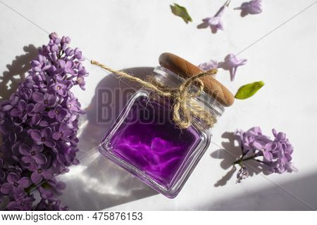 Cosmetic Oil, Lilac Flower On A Light Background