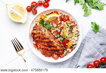 Grilled Chicken Fillet With Bulgur Tabbouleh Salad With Colorful Tomatoes, Parsley And Lemon Dressin