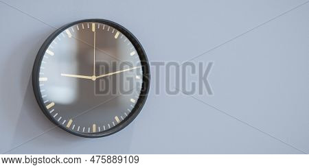 Round Wall Clock Hanging On Grey Wall. Clock On Grey Background. Control, Timing, Time Management, T