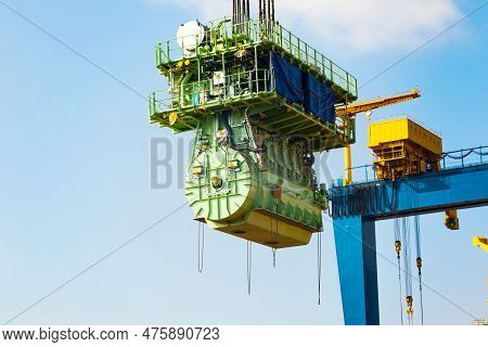 Transportation Of A Large Marine Engine By A Port Crane Using Steel Cables.