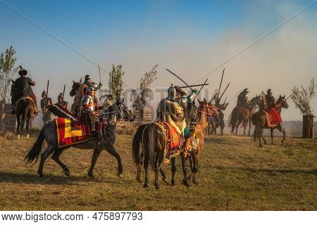 Gniew, Poland, Aug 2020 Winged Hussars, Polish Heavy Cavalry Fight On A Battlefield. Historical Reen