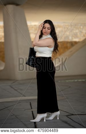 Young Attractive Woman Wearing Casual And Holding A Handbag Clothing Walking Outdoors In The City.