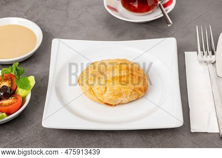 Izmir Boyoz On A White Porcelain Plate On A Stone Table
