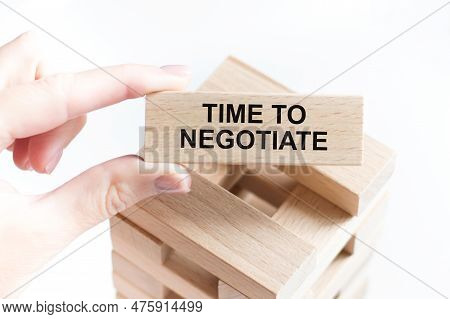 On A Light Background, Wooden Cubes And A Wooden Block With The Text Time To Negotiate. View From Ab