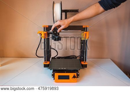 Technological Hi-teg Tool For Making New Things. A Black And Red 3d Printer At Work. The Object Is C