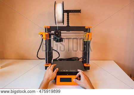 Technological Hi-teg Tool For Making New Things. A Black And Red 3d Printer At Work. The Object Is C