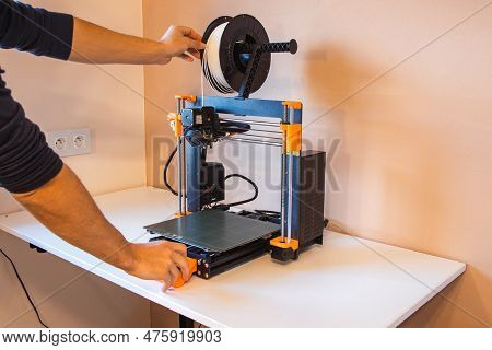 Technological Hi-teg Tool For Making New Things. A Black And Red 3d Printer At Work. The Object Is C