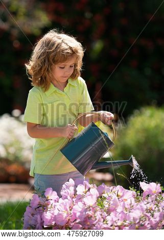 Active Kid Watering Plants On Backyard. Child Helping Arents To Grow Herbs And Flowers In Garden.
