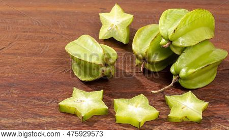 Star Fruit Or Carambola Green - Averrhoa Carambola; Photo On Wooden Background