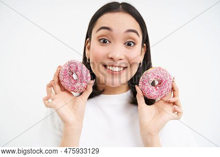 Smiling Korean Woman Eats Pink Glazed Doughnuts, Enjoys Delicious Donnut, Junk Food, Not Care About 