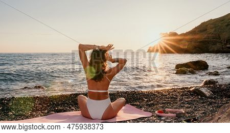 Woman Sea Yoga. Happy Woman In White Swimsuit And Boho Style Braclets Practicing Outdoors On Yoga Ma