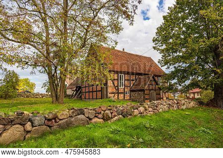 Trees, Stone Wall And Building In Carwitz, Germany.