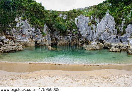 Playa De Gulpiyuri, Flooded Sinkhole With Inland Beach Near Llanes, In Asturias Northern Spain, Arou