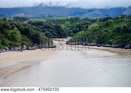View On Playa De Poo During Low Tide Near Llanes, Green Coast Of Asturias, North Spain With Sandy Be