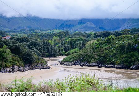 View On Playa De Poo During Low Tide Near Llanes, Green Coast Of Asturias, North Spain With Sandy Be
